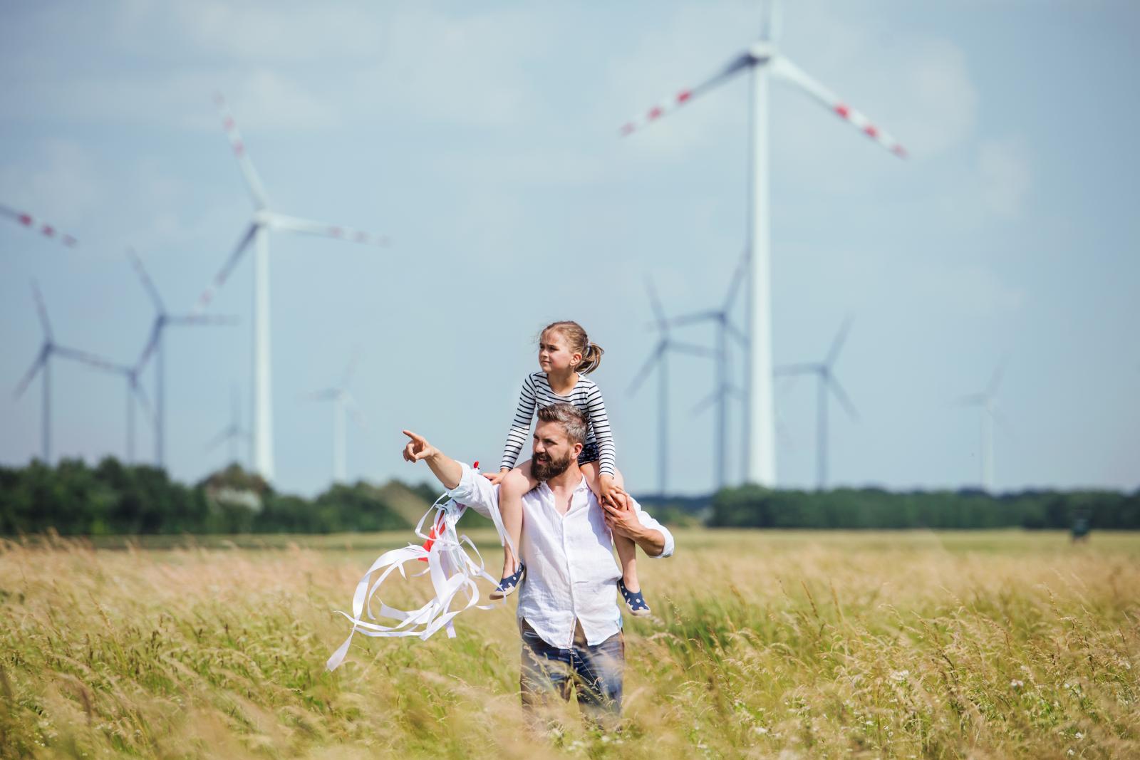 Family walking next to a wind farm
