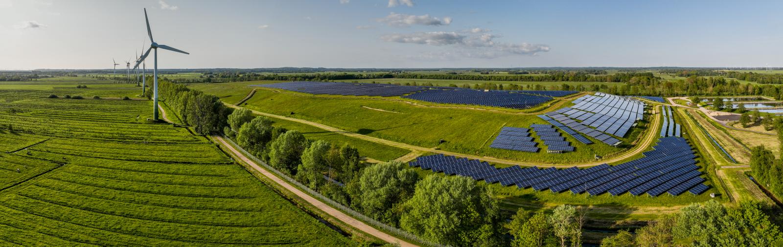 Solar panels farm built on a waste dump and wind turbine farm